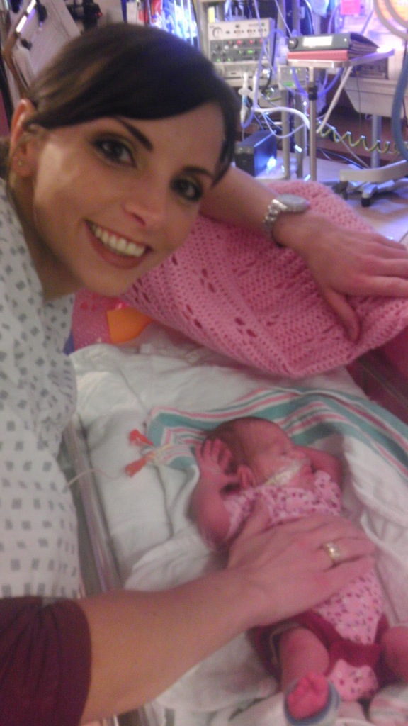 Amanda smiling next to a baby